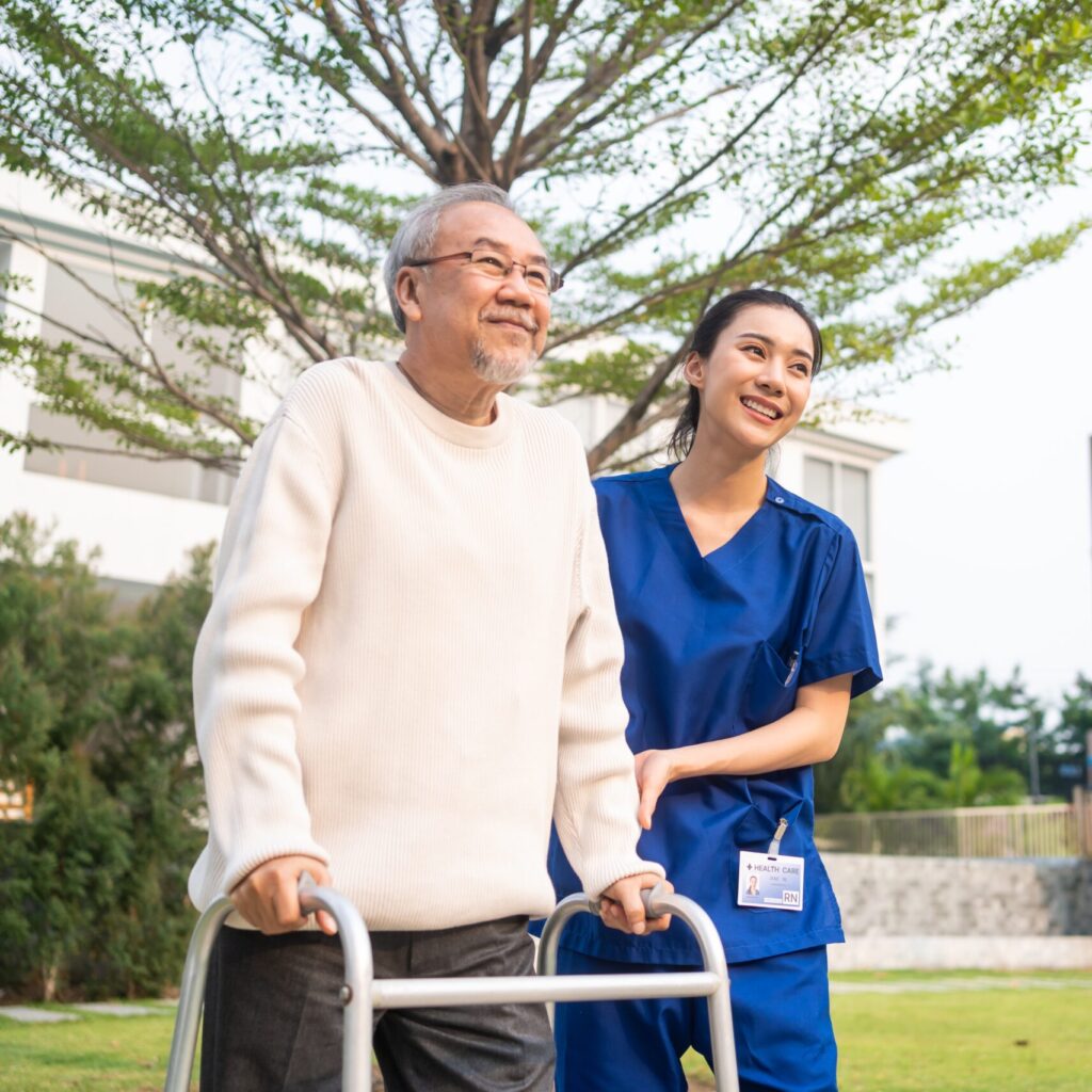 Asian,Young,Caregiver,Nurse,Support,Senior,Older,Male,Walking,Outdoors.